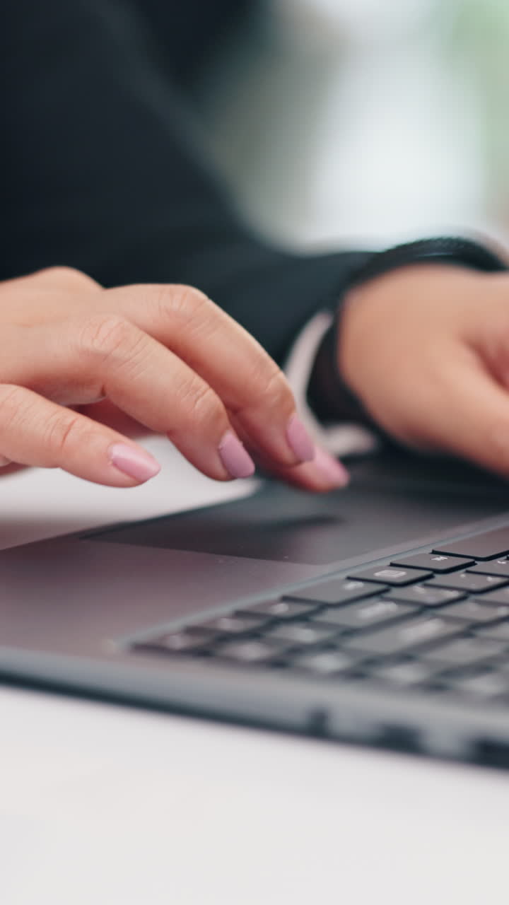 Hands typing on a laptop keyboard
