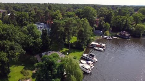 gorgeous aerial drone flight panorama overview drone shot over a river with boats sun reflection
aerial view luxury villa forests lake potsdam germany summer 2021