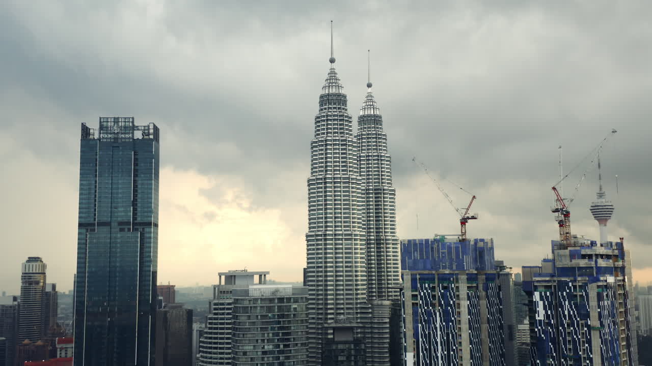 Petronas Twin Towers behind the Star Residences buildings under construction, drone shot