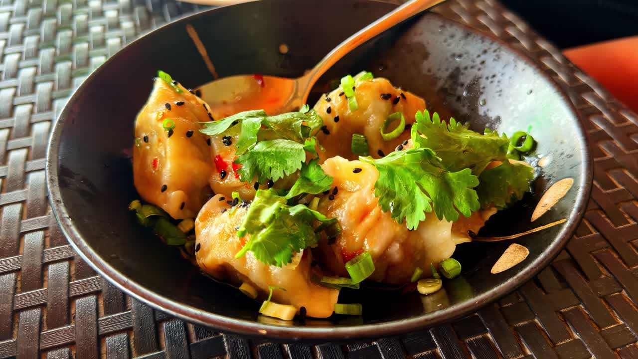 Spicy Asian dumplings in a black bowl served at Catangnan Philippines