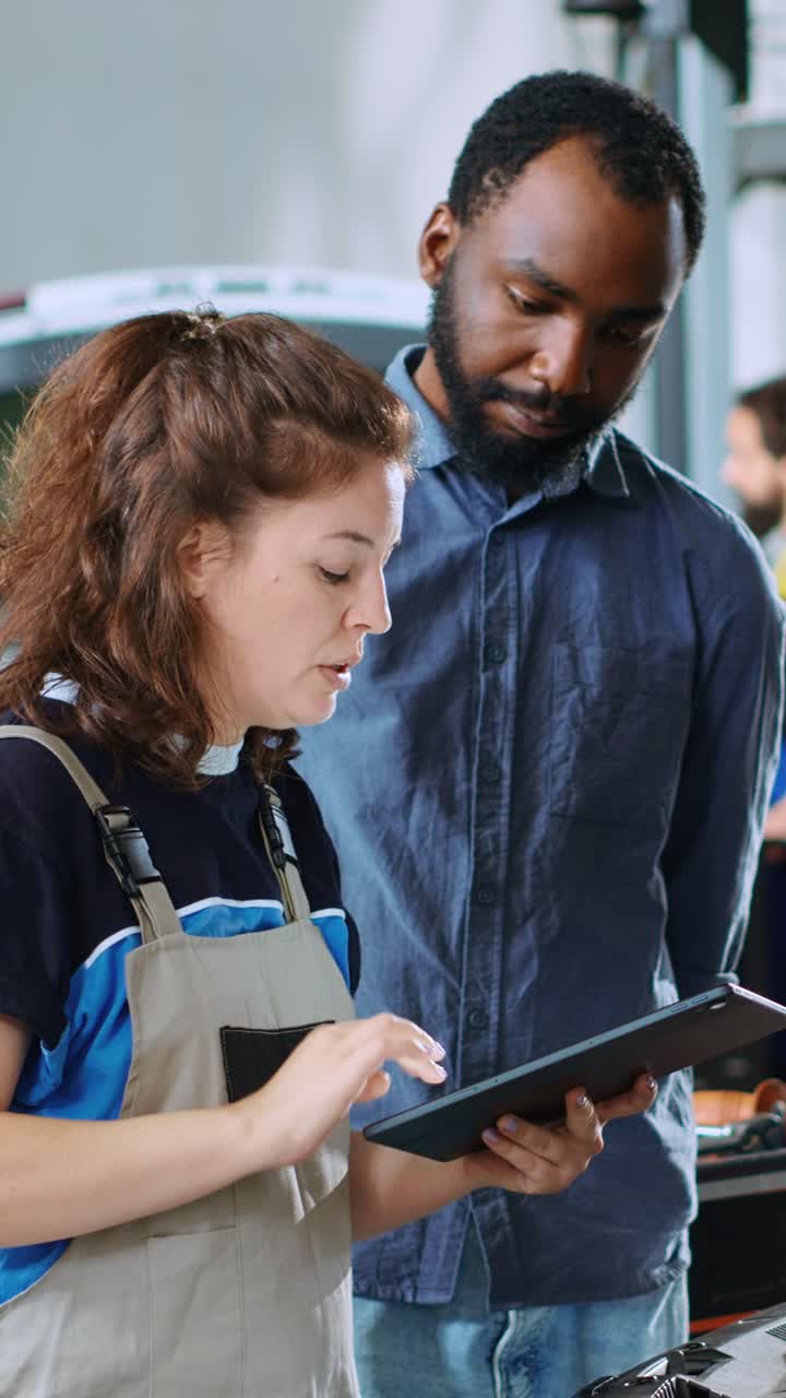 Vertical video Engineer informs man of car repair costs