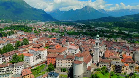 soar above belluno, italy, in this breathtaking drone video, capturing the stunning dolomite mountains framing the charming medieval town below