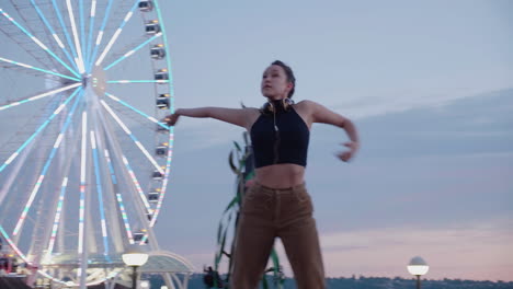 young, female, contemporary dancer near an urban ferris wheel