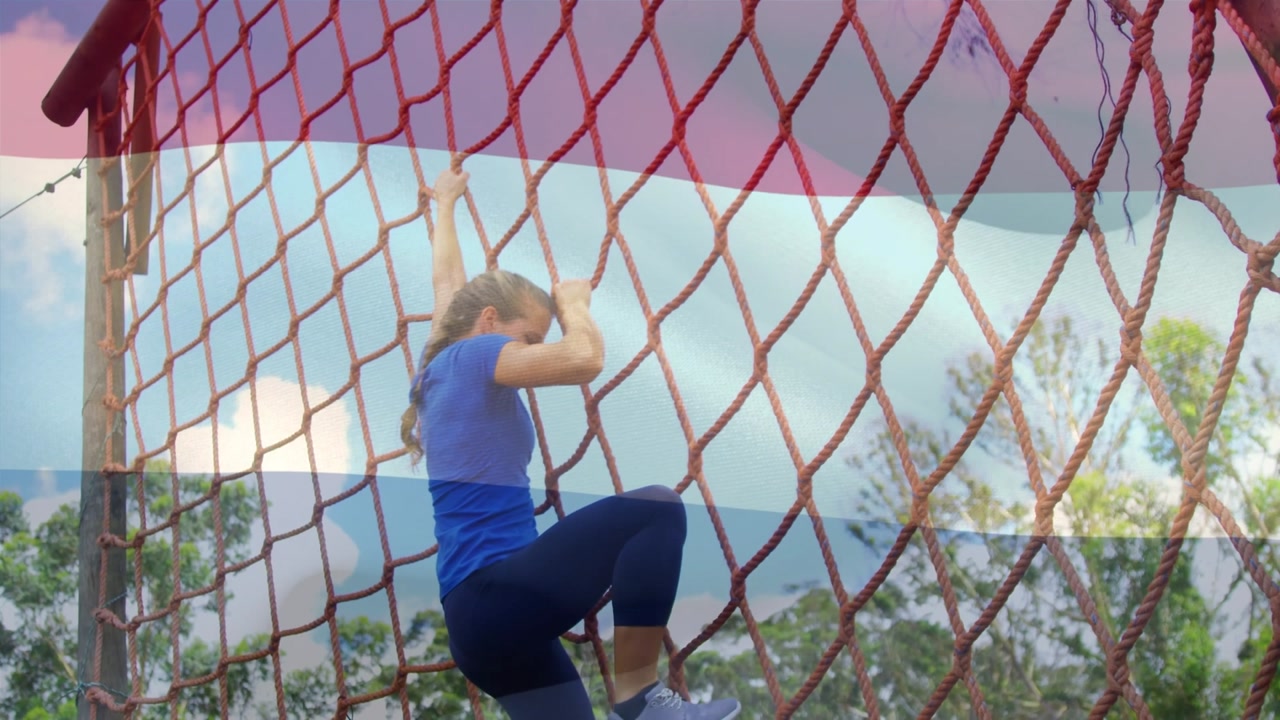 Animation of flag of netherlands over caucasian woman during obstacle race training
