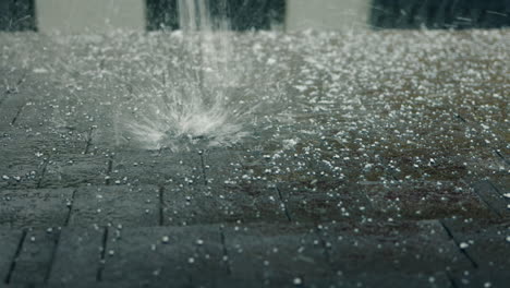 hail and rain on a paved surface
