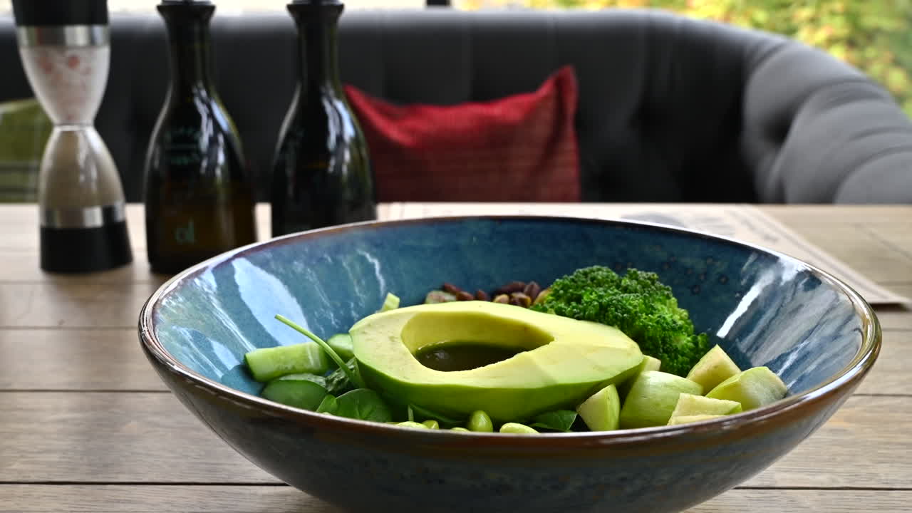 Close up of a blue bowl of chopped green vegetables