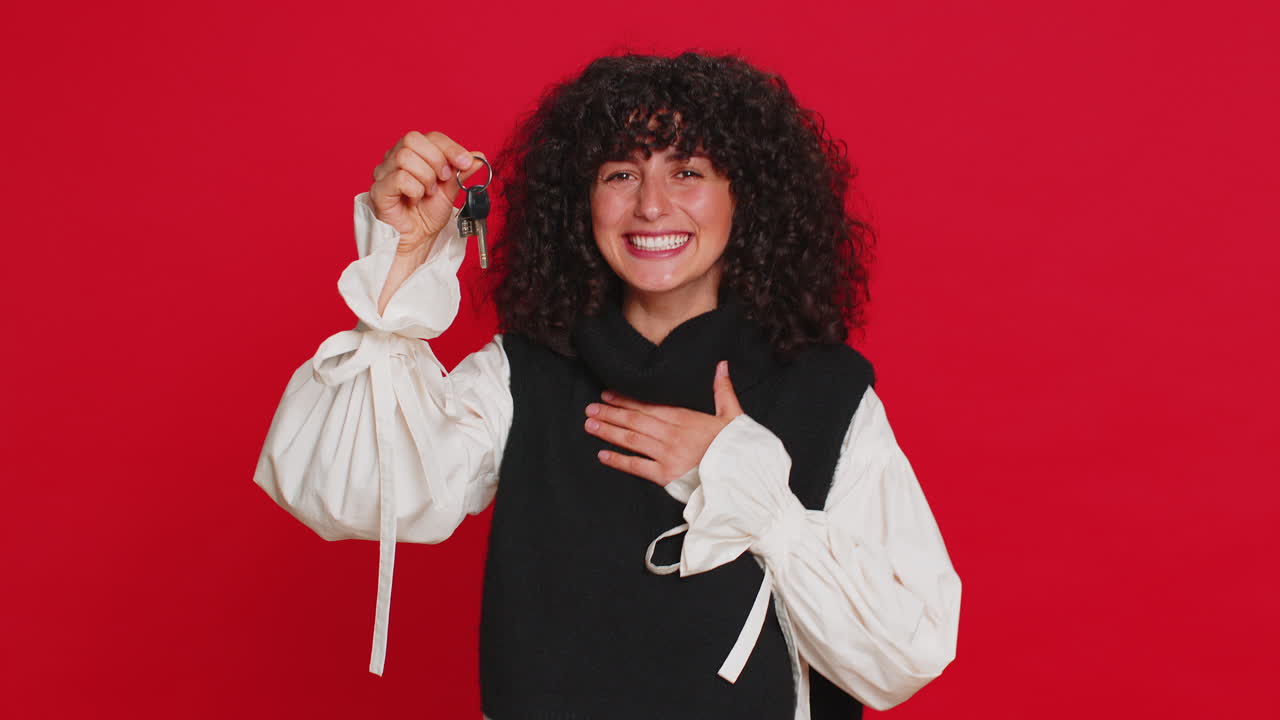 Caucasian woman real estate agent showing keys of new home house apartment buying renting property