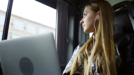 woman traveling by car and listening to music