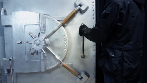 a bank robber breaks into a bank vault and opens the safe door