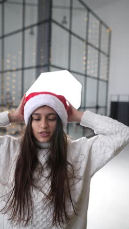 woman wearing santa hat in a studio setting