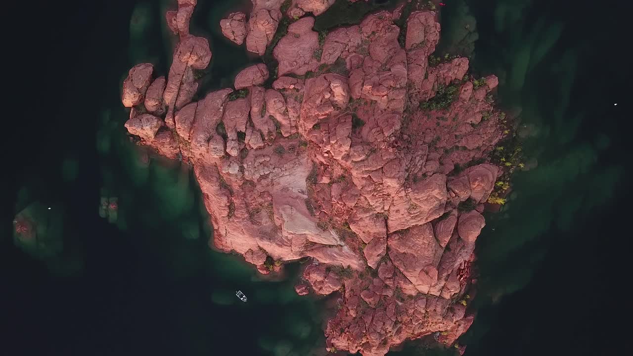Red Rock Islet in Deep Water of Sand Hollow State Park Lake, Spinning Top Down Aerial View
