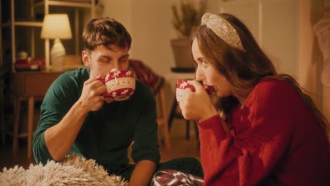 Man-toasting-coffee-cup-and-drinking-with-female-friend