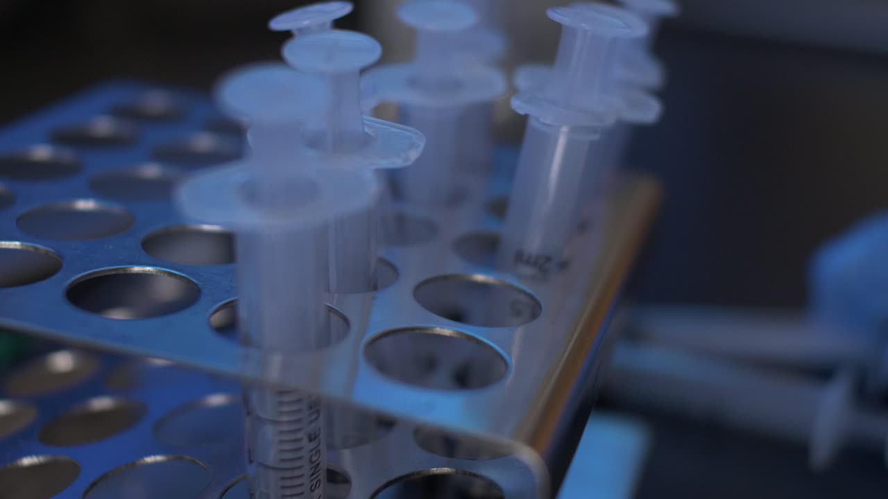 Empty Disposable Syringes Taking Out Of Metal Rack