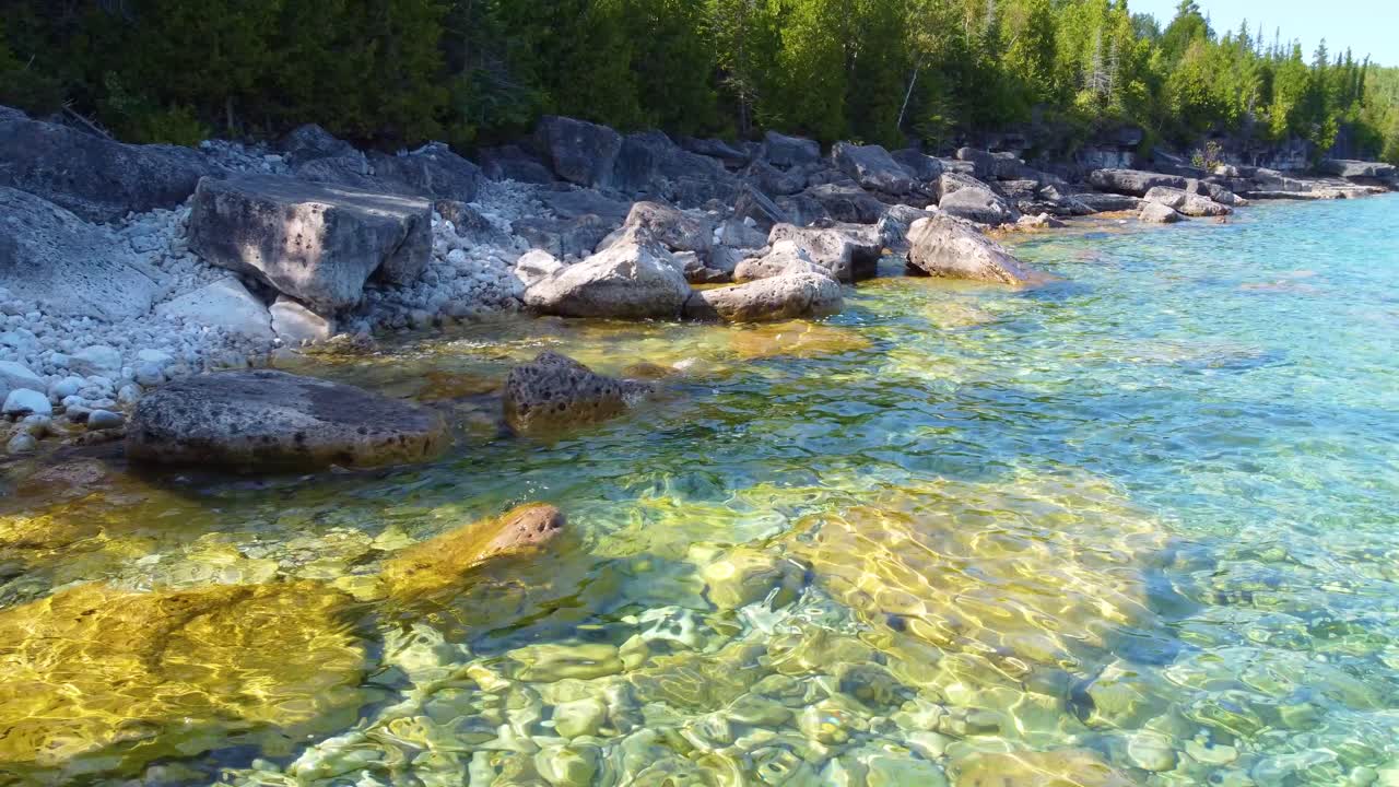 Flying low over rocks and crystal clear waters in Georgian Bay, Ontario