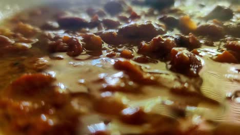 Middle-Eastern-ful-medames-fava-bean-mashed-up-closeup-steam-rising-breakfast-meal-inspired-by-Lebanese-with-tahini-olive-oil-lemon-juice-garlic-and-some-salt