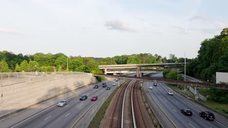 aerial view of transportation in urban highways with rail tracks, state route 400 in buckhead, atlanta, georgia