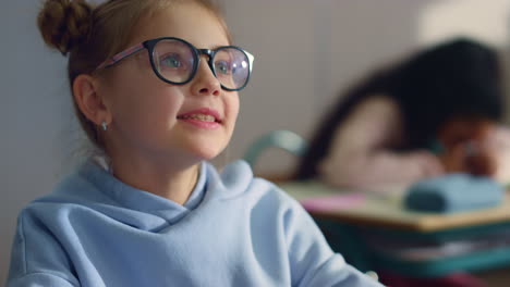 girl answering for question at lesson in school. student talking in classroom