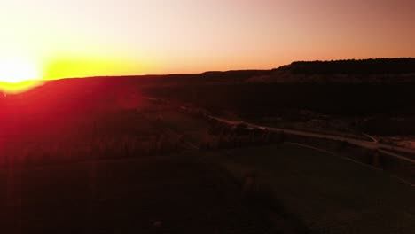 sunset over farmland and mountains