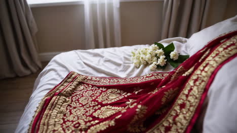 indian saree with flowers on bed