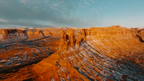 cinematic pan from a snowy sunrise in valley of the gods utah