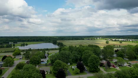 beautiful aerial footage of a suburban neighborhood with a scenic lake and open fields