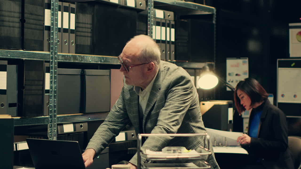 Senior private agent working on criminal report with classified data