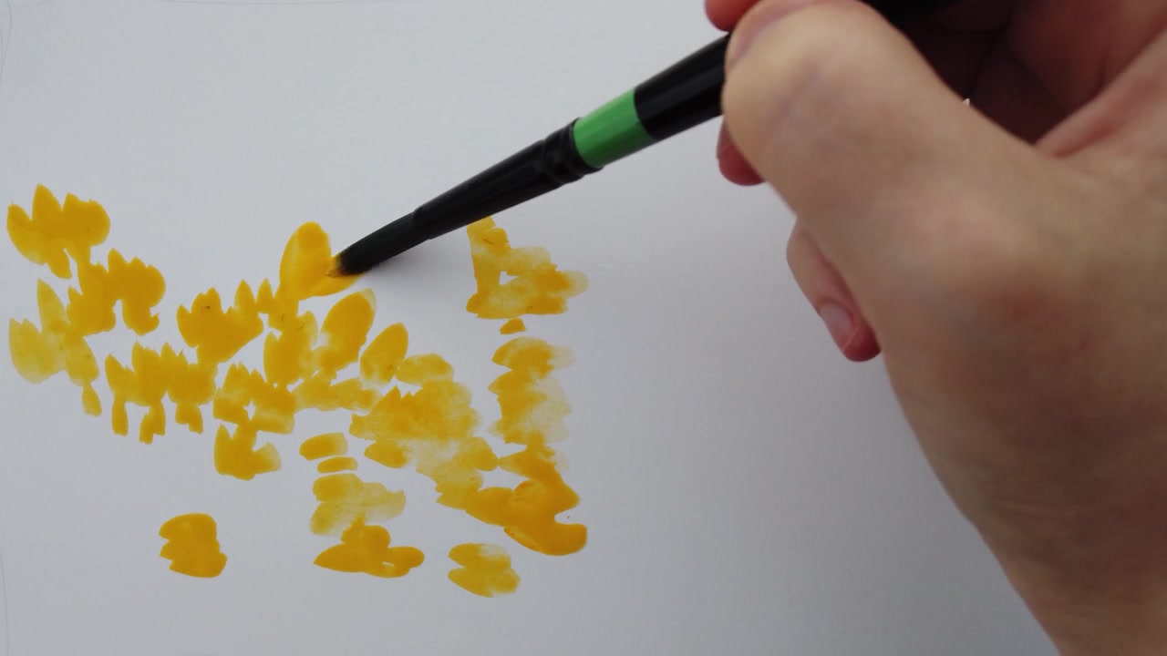 Drawing on paper with watercolor paints.