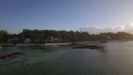 flying over coastal resort and green areas of mauritius island