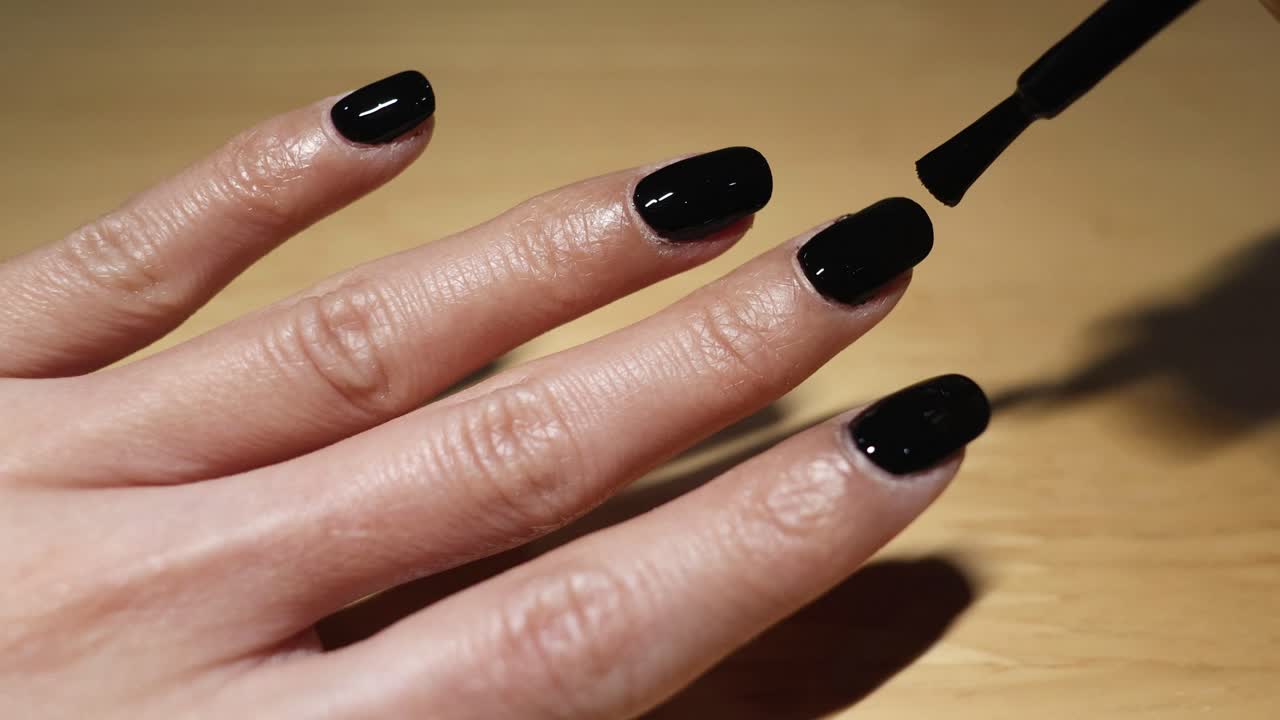 Sequential application of black nail polish