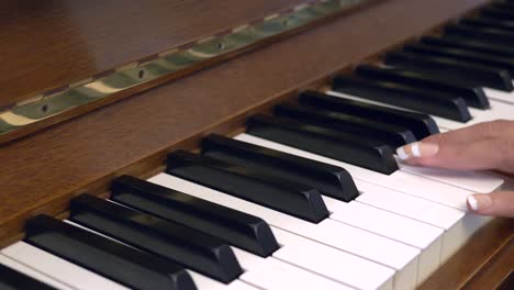 Close-up-shot-of-female-hands-playing-piano