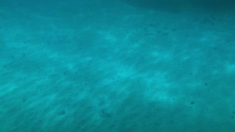 Sun-dances-along-the-sandy-bottom-as-we-prepare-to-snorkel-the-reef-system