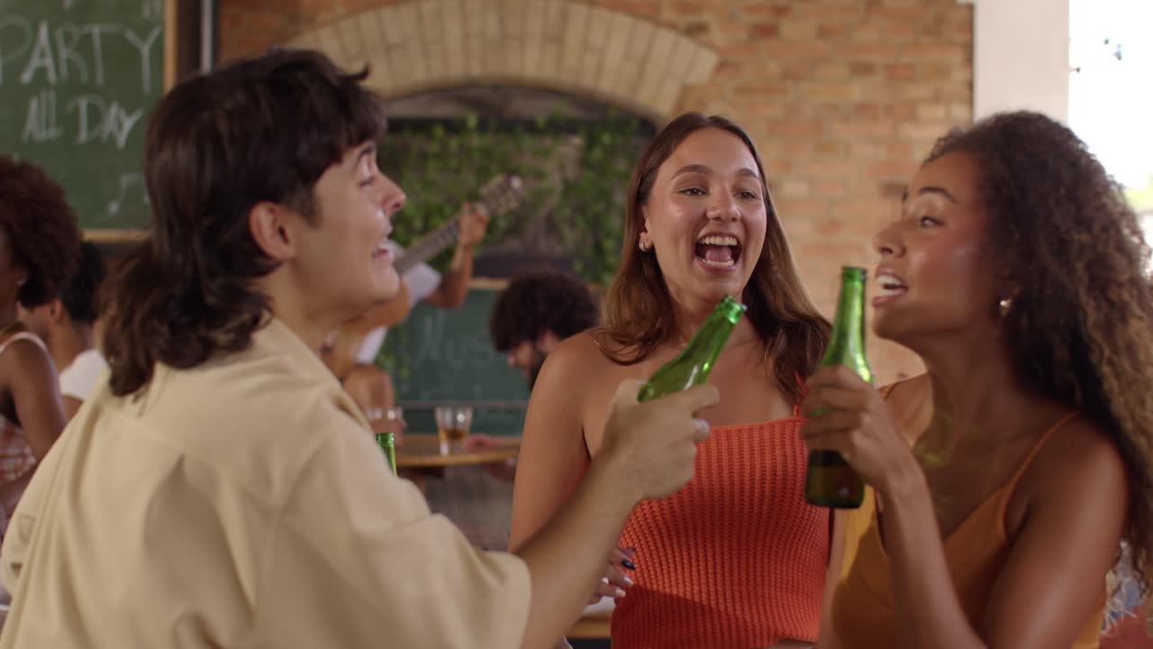 Diverse Group of Friends Enjoying a Lively Party with Drinks and Music