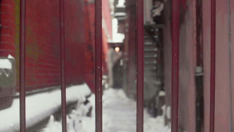 fenced off snowy alley way