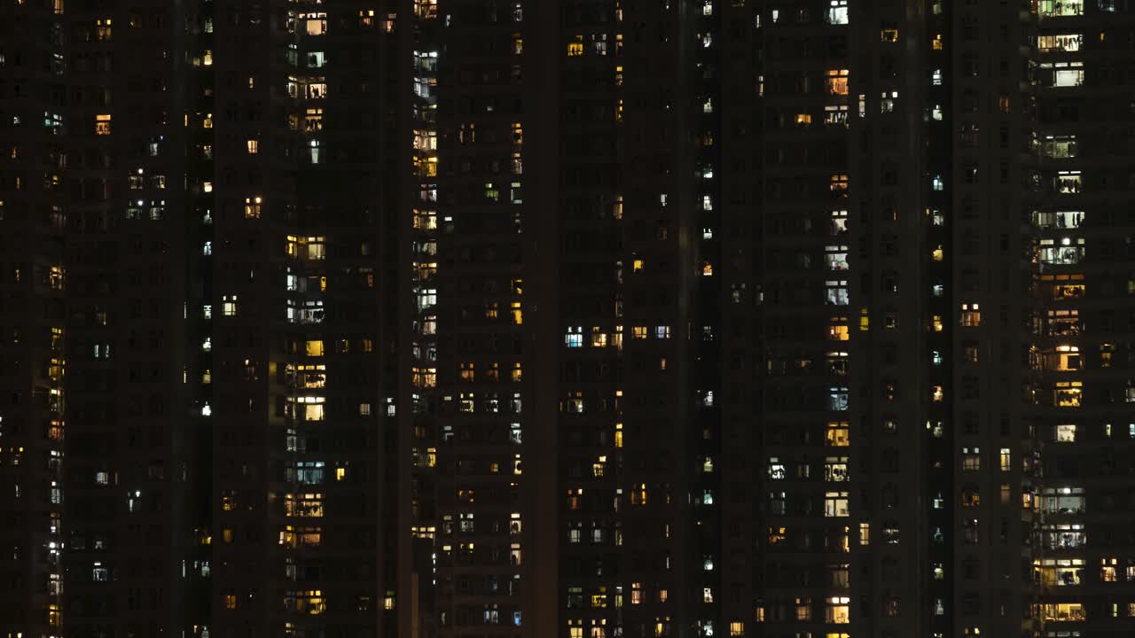 Time lapse of day to night transition of apartment buildings.