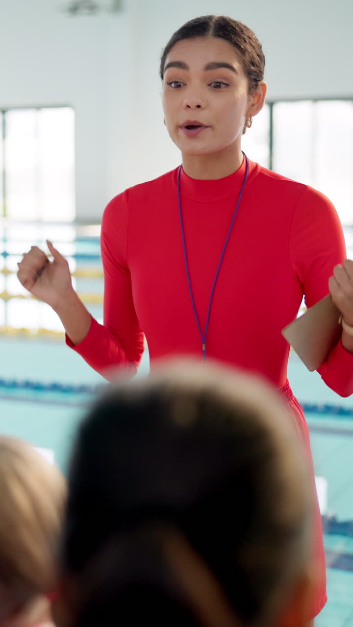 Swimming Coach Interacting with Students