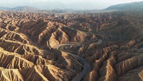 aerial textured landscape, wild road through kyrgyzstan canyon of forgotten rivers, geological magnificent area
