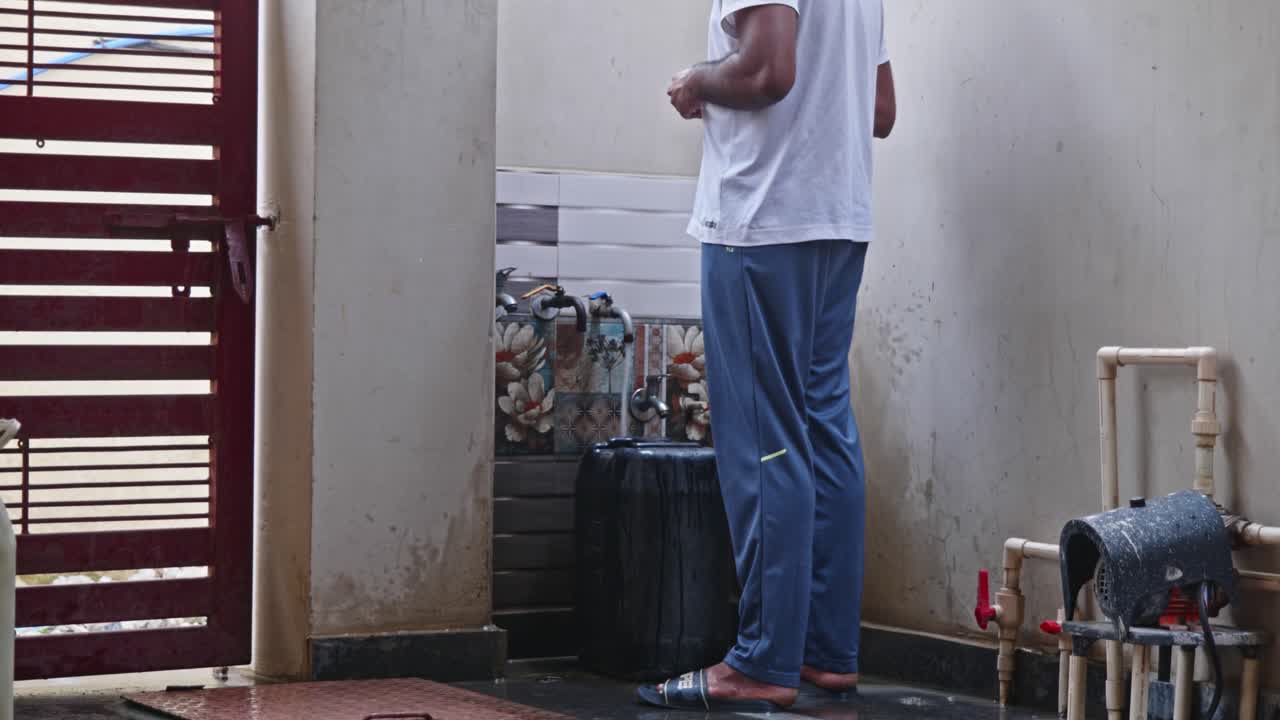 Person filling telangana municipal water or godavari river water in plastic Container for storage at home. day time, stable shot, 4k