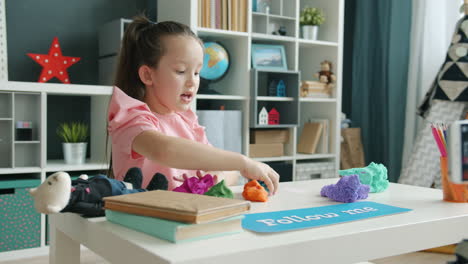 girl playing with kinetic sand