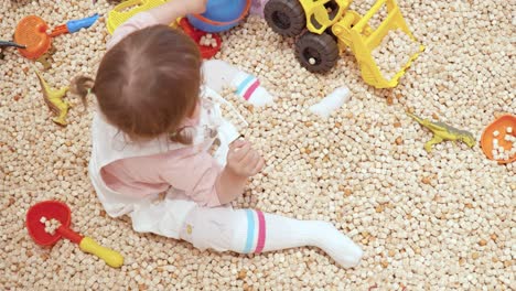 Toddler-Playing-Toy-Bucket-On-Playpen-Then-Another-Child-Take-It-Away-From-Her