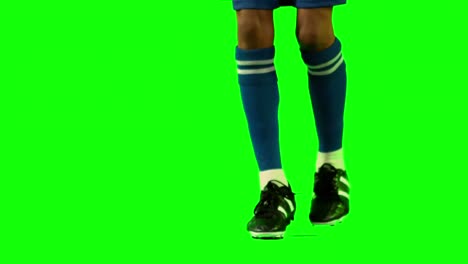jugador de fútbol que controla el balón