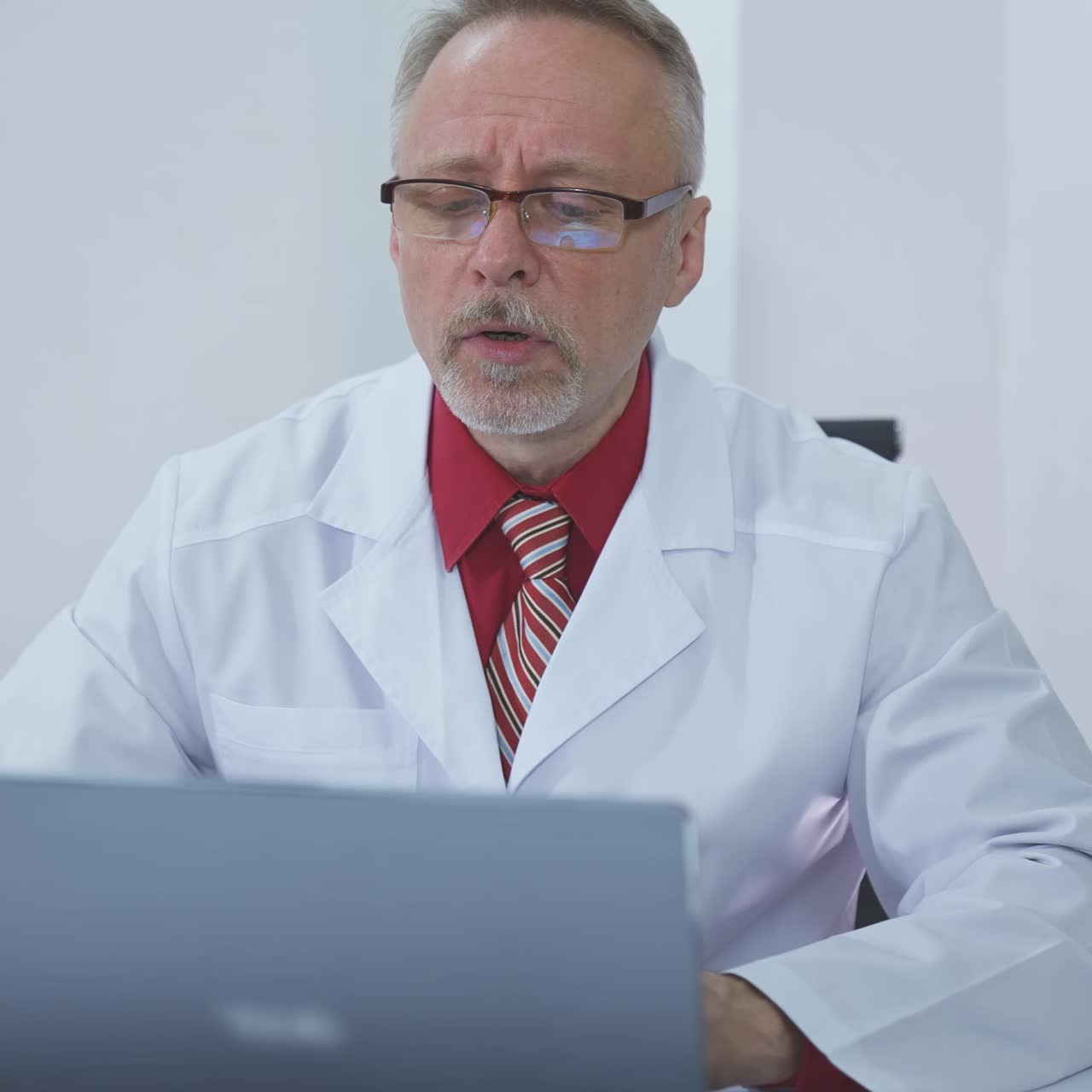 Doctor sitting at his desk and thinking about difficult case he had at work