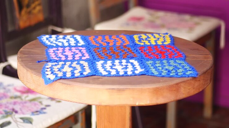 Colorful Crochet Blanket on a Wooden Stool