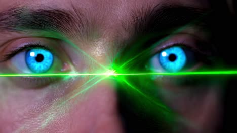 man's eyes with green laser