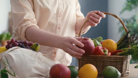 woman pull in apple and other fruits lying around after the shopping.