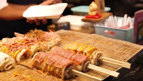 vendor serves freshly made rice rolls in krabi