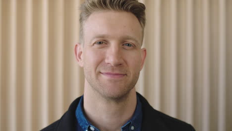 close-up-portrait-of-attractive-caucasian-man-looking-confident-at-camera-smiling-positive