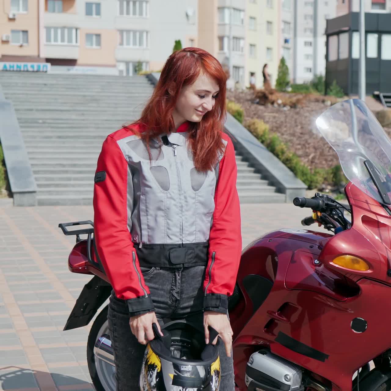 Girl biker mounts motorcycle