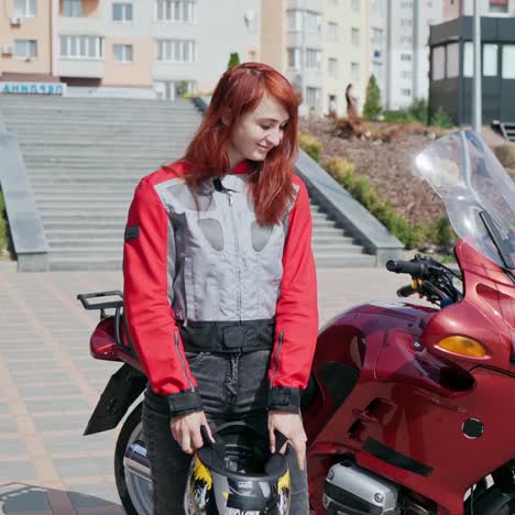 girl biker mounts motorcycle
