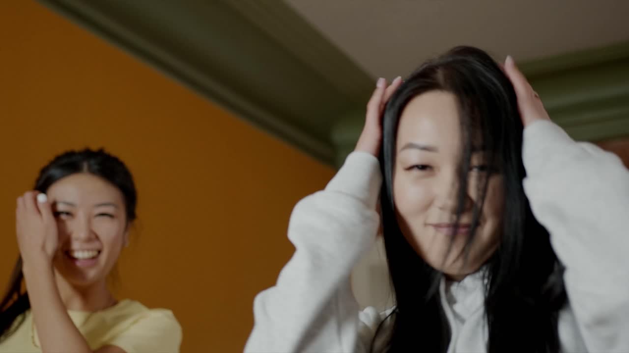 People in hoodies dancing in front of LED lights