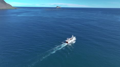 Navigating-Cargo-Fishing-Ship-Across-The-Sea-Of-Faskrudsfiord-Bay-Near-Skrudur-Island-In-East-Iceland